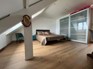 a bedroom with a bed and a large window at En bord de mer, vue et accès direct à la plage in Batz-sur-Mer