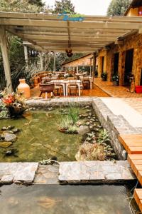 a patio with a koi pond in a yard at Entrebosques in Santa Elena
