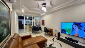 a living room with a couch and a flat screen tv at Single Home 2brs2baths Phuket Kathu Townkis in Ban Huai Luk (1)