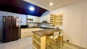 a kitchen with a counter and a refrigerator at Single Home 2brs2baths Phuket Kathu Townkis in Ban Huai Luk (1)