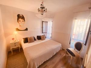 a bedroom with a bed and a portrait of a woman at Bungalow Paraiso in Callao Salvaje