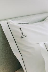 a bed with a pillow with a name on it at Hotels 705 Porto Prime Home in Porto