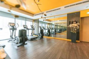 a gym with treadmills and ellipticals in a room at Gorgeous Apt Studio with balcony in Business Bay in Dubai