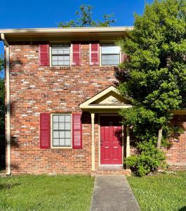 a brick house with red shutters and a red door at Charming 3BR 1.5BA Cozy Haven in Rome