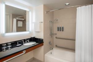 a bathroom with a sink and a shower with a mirror at The Westin Boston Seaport District in Boston