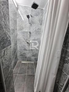 a bathroom with a shower with a shower curtain at Villa Dalmacija in Prijedor