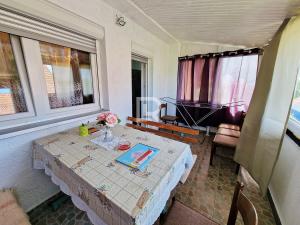 a room with a table with a vase of flowers on it at Villa Dalmacija in Prijedor +15 photos