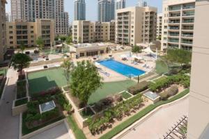 an aerial view of a swimming pool in a city at Unique 1Bedroom with Balcony Greens Dubai in Dubai