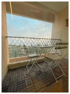 a balcony with a table and two chairs on it at Malaya suite in Caesarea