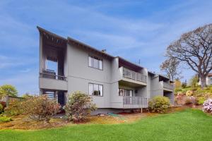 a large white building with a grass yard at Port Ludlow Resort Condo 2 in Port Ludlow