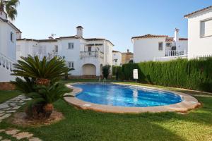a swimming pool in the yard of a house at Peony by ON Travel in Oliva