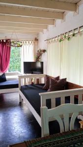 a bedroom with two beds and a tv in a room at Cabaña,Chalet Alpino Bosques de Peralta Ramos in Mar del Plata