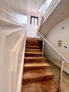 a staircase in a house with wooden floors at Sublime Villa in Cotonou