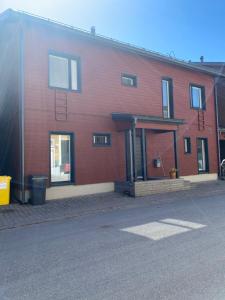 a large red brick building with a door on it at Tranquil studio near nature, free parking& wifi in Helsinki