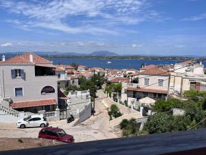 a view of a city with cars parked on a street at Captain's Studios in Spetses