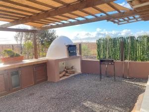 a outdoor kitchen with a pizza oven in a patio at La Pradera in Antigua
