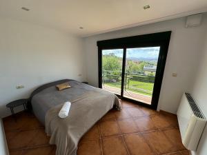 a bedroom with a bed and a large window at Casa familiar vista Rías in Vigo
