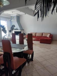a living room with a table and chairs and a couch at Rafaela's Apartment in Kavála