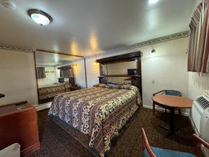 a hotel room with a bed and a mirror at Royal Motel in Secaucus