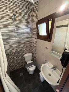 uma casa de banho com um WC e um lavatório em Escape at Ammouliani em Ammouliani