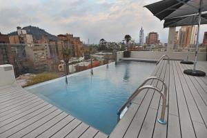 a pool with a surfboard in the middle of it at Hotel Cumbres Lastarria in Santiago
