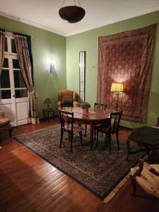 a living room with a wooden table and chairs at 10 Downtown in Cairo