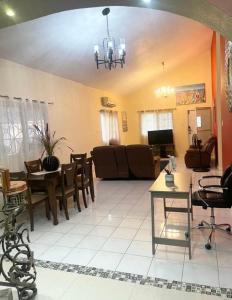 a living room with a couch and a table at Cozy Elegance 3 Bedroom Estate in Portmore