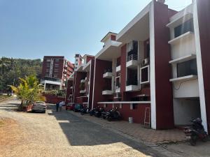 a row of buildings with motorcycles parked next to them at Pixels Luxury Modern Apartment 5 Min to Palolem Beach in Canacona