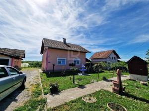a house with a car parked in front of it at Villa Dalmacija in Prijedor