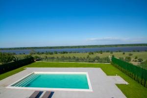 a swimming pool with a view of the water at Vila Julija in Surduk