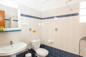 a bathroom with a toilet and a sink at Villa Zeus INN in Paralia Katerinis
