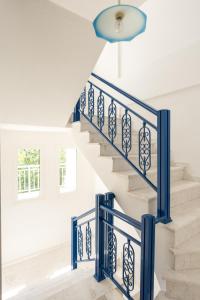 a blue staircase with white walls and blue railings at Villa Zeus INN in Paralia Katerinis