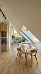 a living room with a table and two chairs at Nida Oasis Apartment in Nida