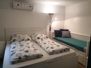 a bed with two pillows on it in a bedroom at LI-DO Vendégház in Balatonfüred