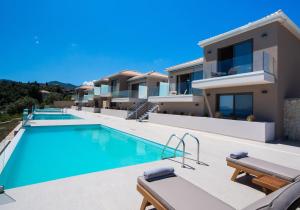 a villa with a swimming pool and a house at Highview luxury suites in Katouna