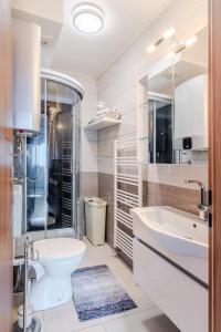 a white bathroom with a toilet and a sink at Penzion Hosnar, apartma Time Out in Bovec +16 photos