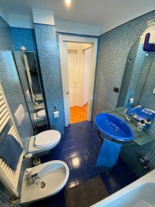 a bathroom with two toilets and a blue sink at Creative Lab in Turin
