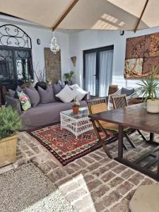 a living room with a couch and a table at Acacia Home in Graaff-Reinet