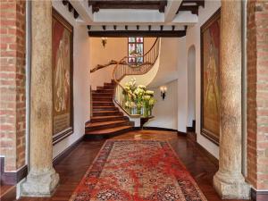 a hallway with a spiral staircase and a rug at Four Seasons Hotel Casa Medina Bogota in Bogotá