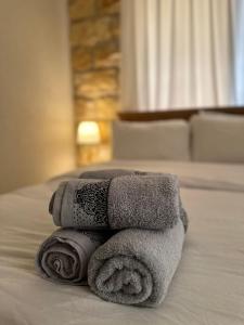 a pile of towels sitting on top of a bed at Via Maria Boutique Suites In The Middle Of The city in Haifa