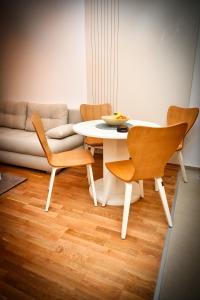 a table and chairs in a living room with a couch at Zlatibor apartman in Zlatibor