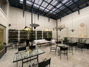 a room with tables and chairs and a room with wine racks at Amérian Executive Córdoba Hotel in Córdoba