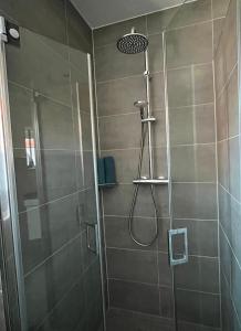 a bathroom with a shower with a glass door at Ferienwohnung "Delftbrise" Emden in Emden