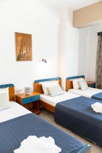 a hotel room with two beds at Villa Zeus INN in Paralia Katerinis