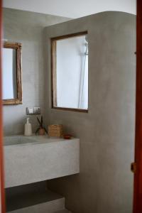a bathroom with a sink and a window at Swallow villa - French guest house in Ahangama