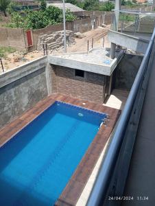 a swimming pool on the roof of a building at Luxe Villa in Cotonou