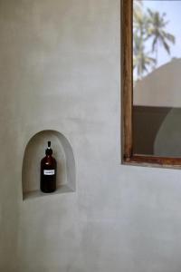 a bottle of soap in a niche in a wall at Swallow villa - French guest house in Ahangama