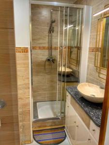a bathroom with two sinks and a shower in it at La Monarette, l'oasis au fond d'un jardin in Sainte-Marie