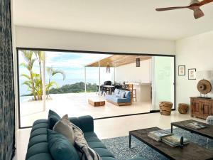 a living room with a blue couch and a table at Casa Canope in Achiote