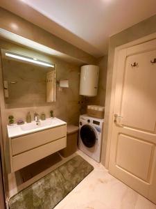 a bathroom with a sink and a washing machine at Holiday Home Nautica in Kotor